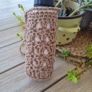 Crochet water bottle holder in cotton worked in a double crochet cluster stitch