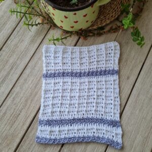 White and blue crochet dishcloth worked in a front post stitch