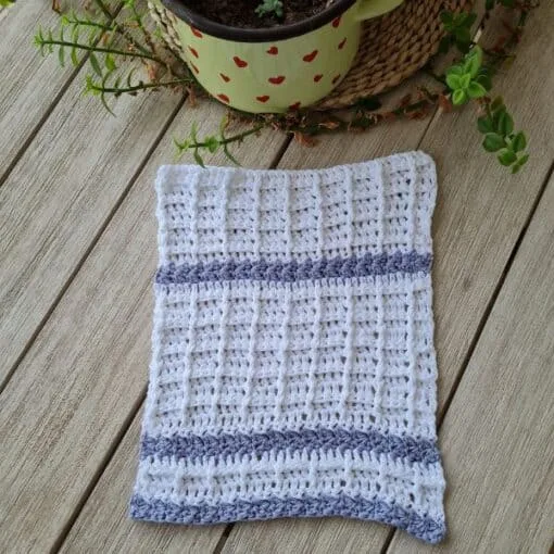White and blue crochet dishcloth worked in a front post stitch