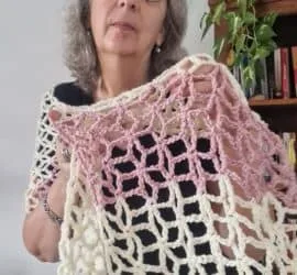 Light cream and blush lace crochet Flower Star shawl wrap draped over the shoulders