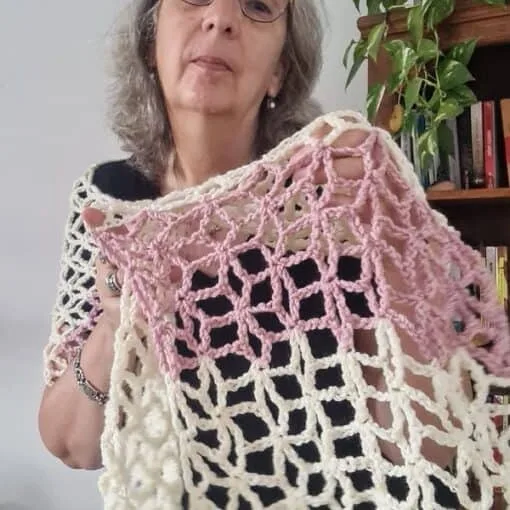 Light cream and blush lace crochet Flower Star shawl wrap draped over the shoulders