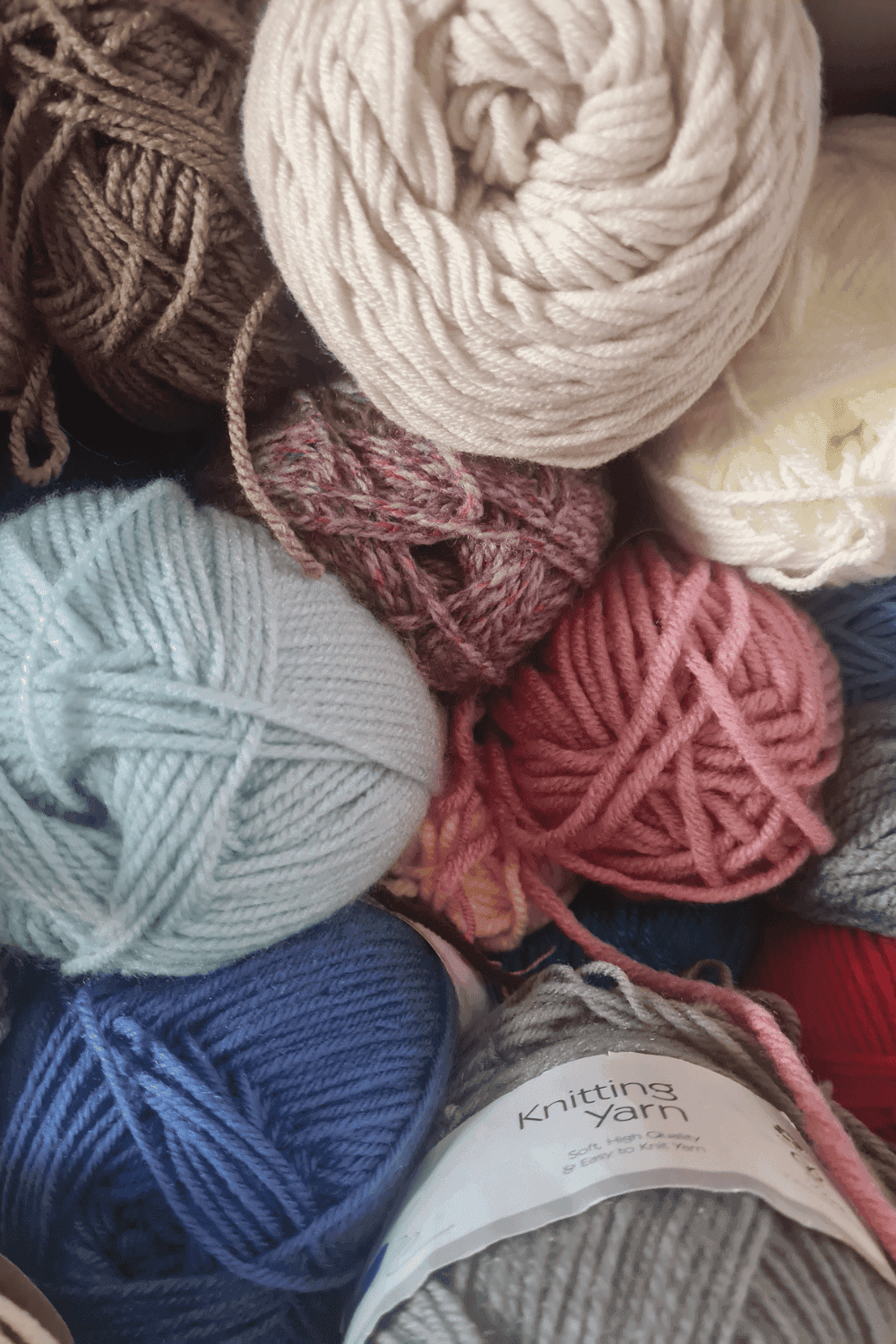 Assorted balls of soft yarn in various colors for knitting and crochet projects.