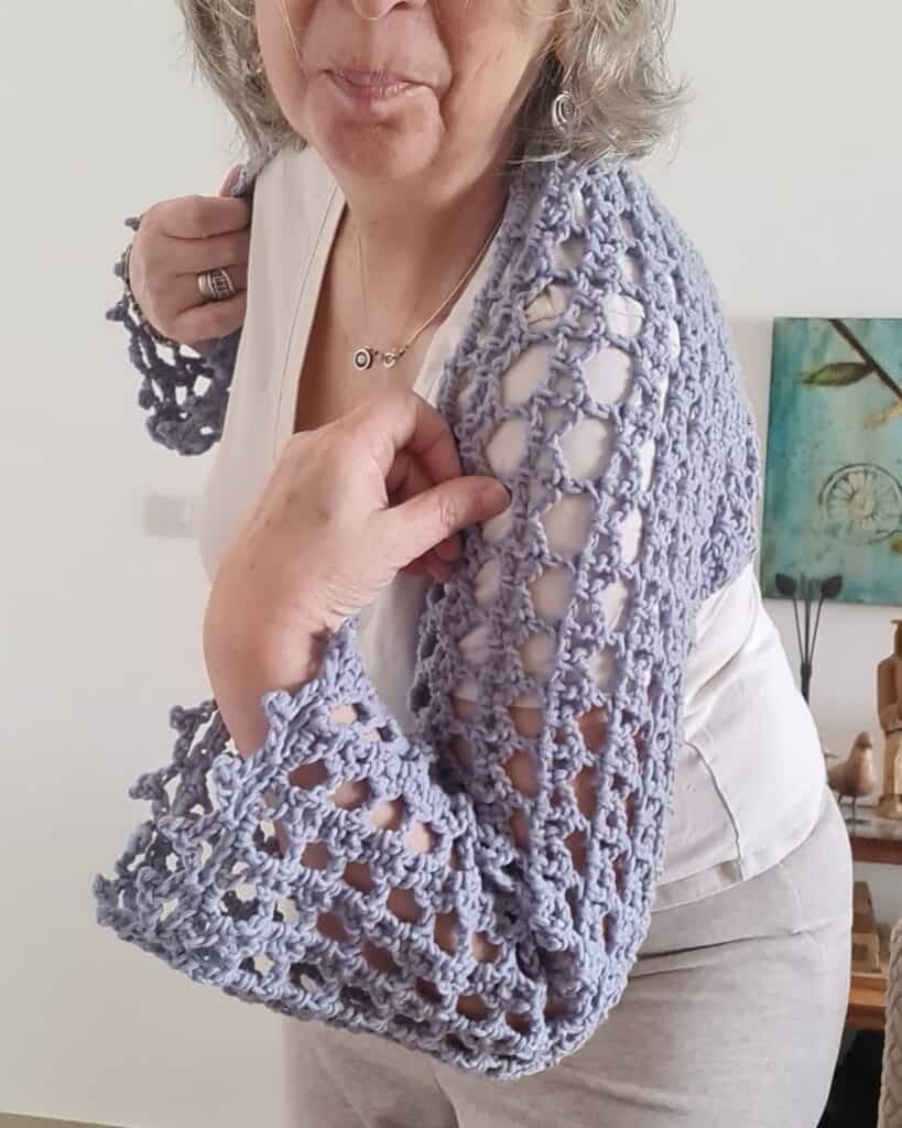 Breeze Shrug — Lightweight open-weave crochet summer shrug in  ligth blue  worn over a simple top