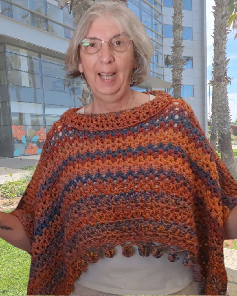 One-Rectangle Poncho — Crochet V-stitch poncho in warm colors variegated yarn with pom-pom trim