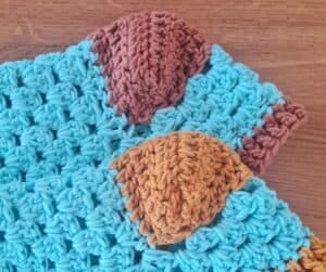 Close up of the granny stitch texture on the foot of a crochet slipper