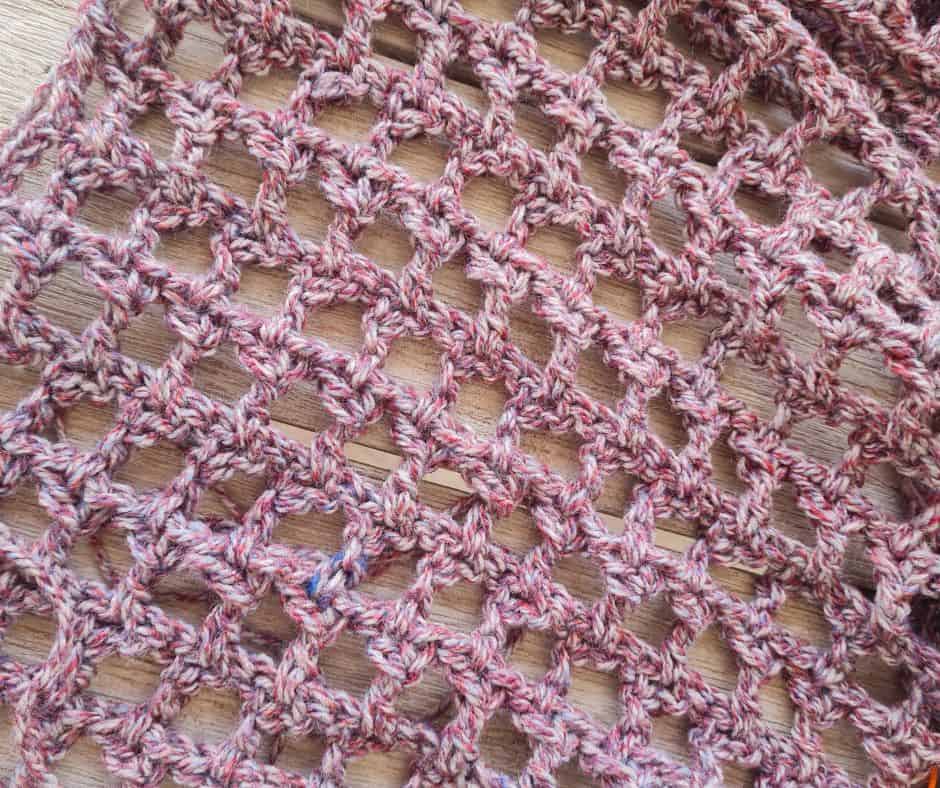 Close up of the open Y stitch mesh fabric that forms the body of the crochet shrug