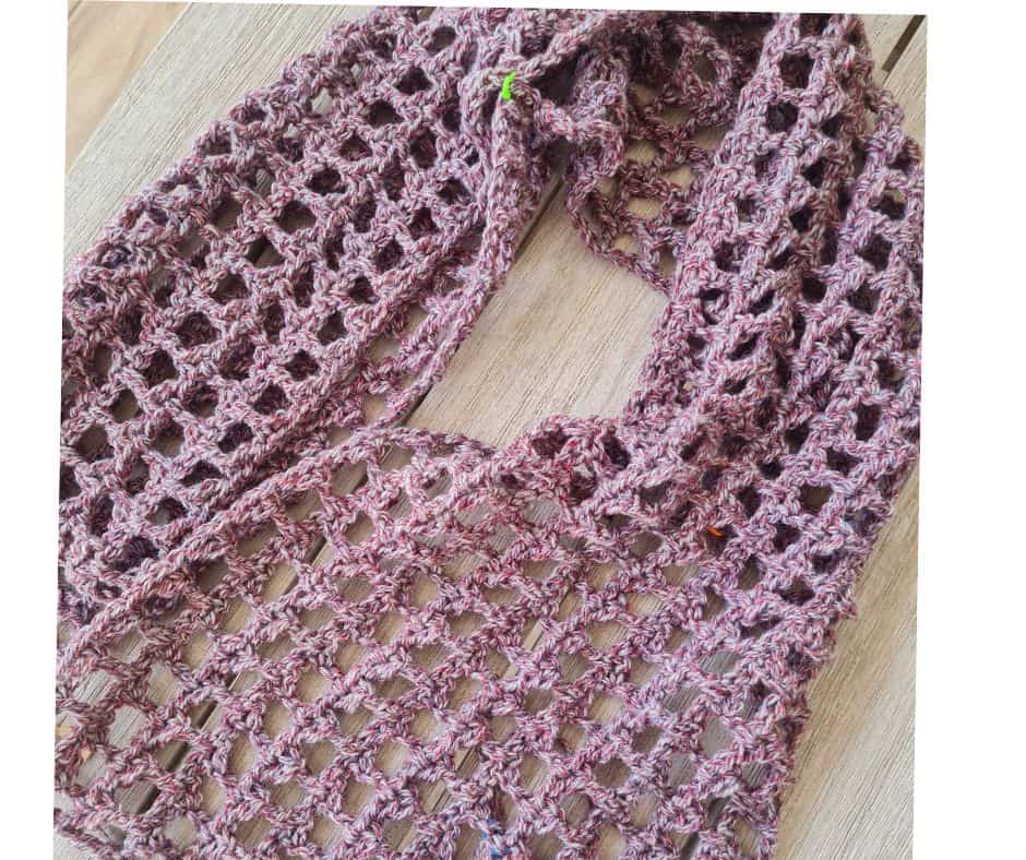 A long crochet rectangle folded in half and seamed at the sides to form the sleeves of a mesh shrug