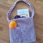 Pink and beige crochet bag with a long strap, made from two strands of yarn held together