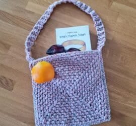 Pink and beige crochet bag with a long strap, made from two strands of yarn held together