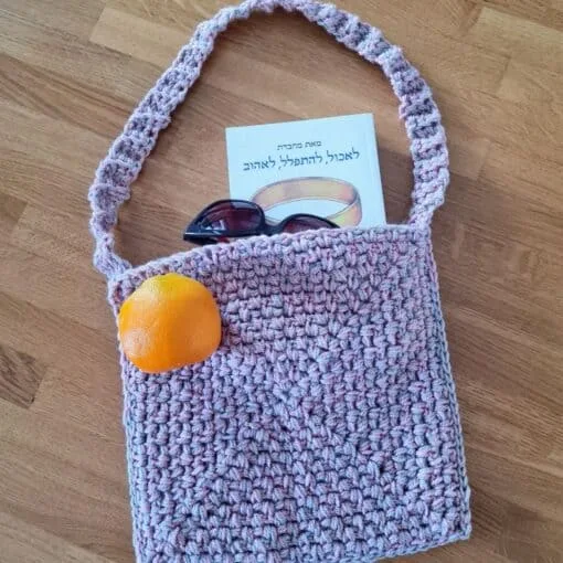 Pink and beige crochet bag with a long strap, made from two strands of yarn held together