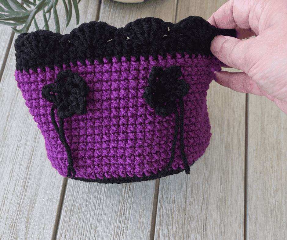 Purple and black crochet basket with black flower,