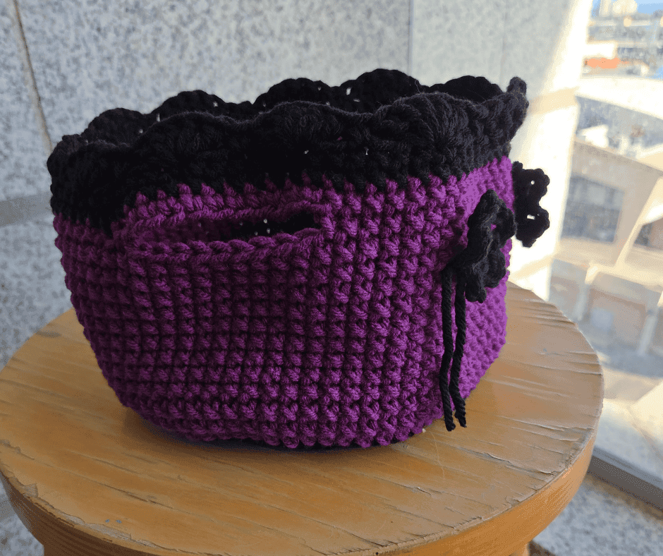 Finished purple and black crochet basket with flower