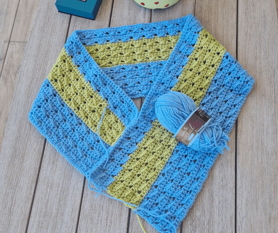 Crochet poncho wrap laid flat showing open construction before joining